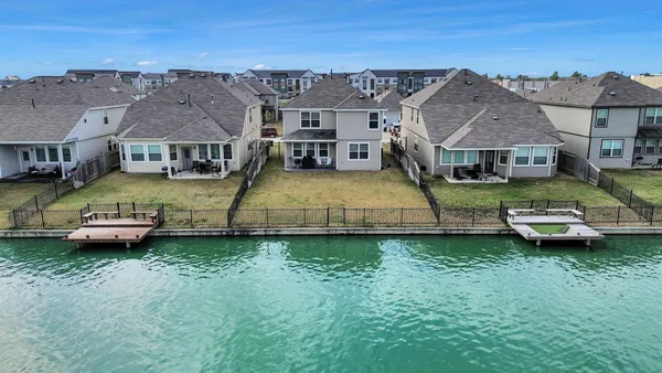 an aerial view of a house with swimming pool garden view and a lake view