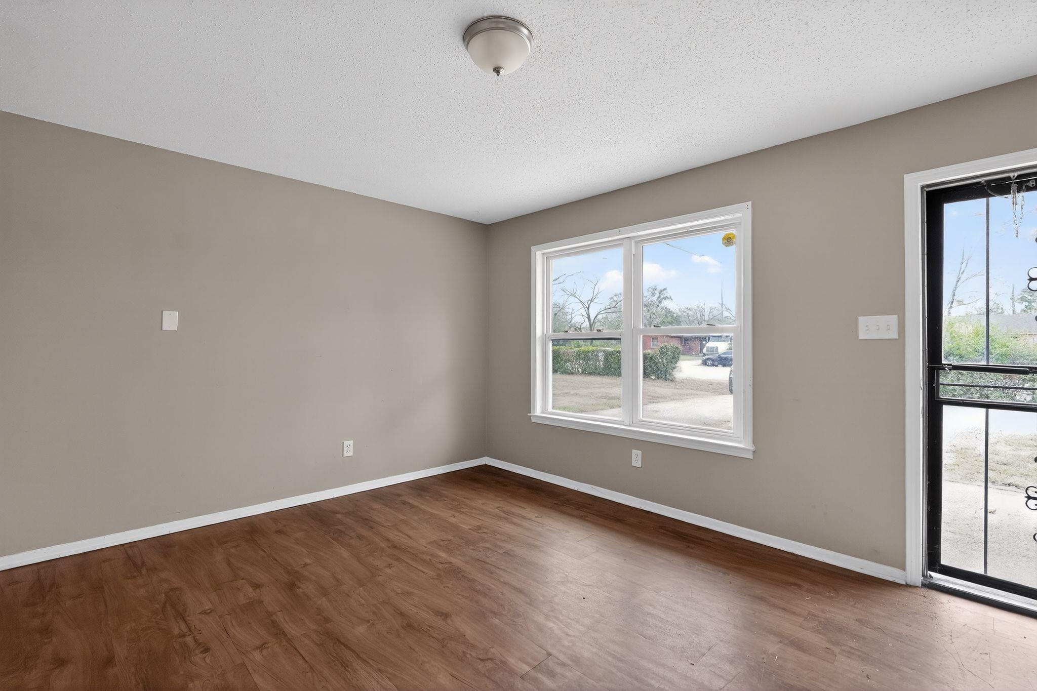 4314 Ford Road Memphis, TN 38109 - Photo 15 of 31 an empty room with wooden floor and windows