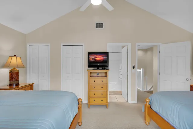 a bedroom with bed and large windows