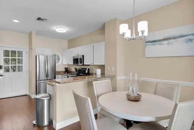 a kitchen with cabinets stainless steel appliances and a counter space