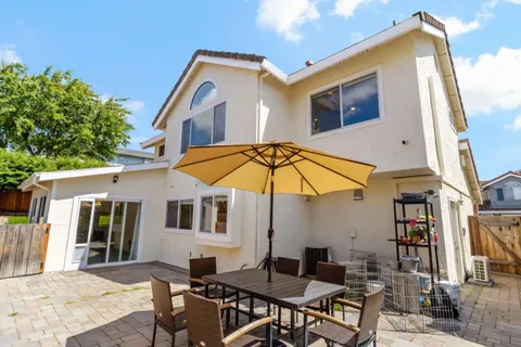 a patio with a table and chairs