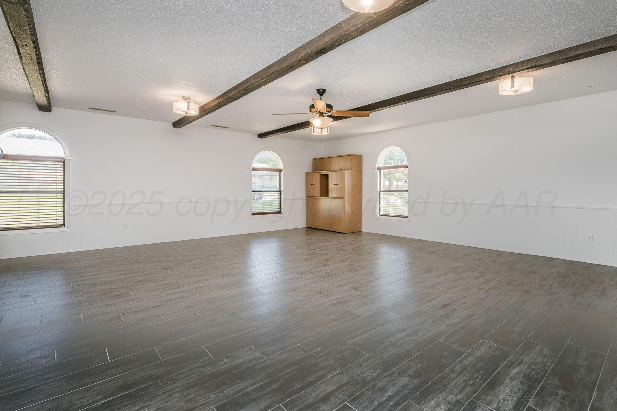1102 Creekmere Drive Canyon, TX 79015 - Photo 12 of 29 an empty room with wooden floor and window