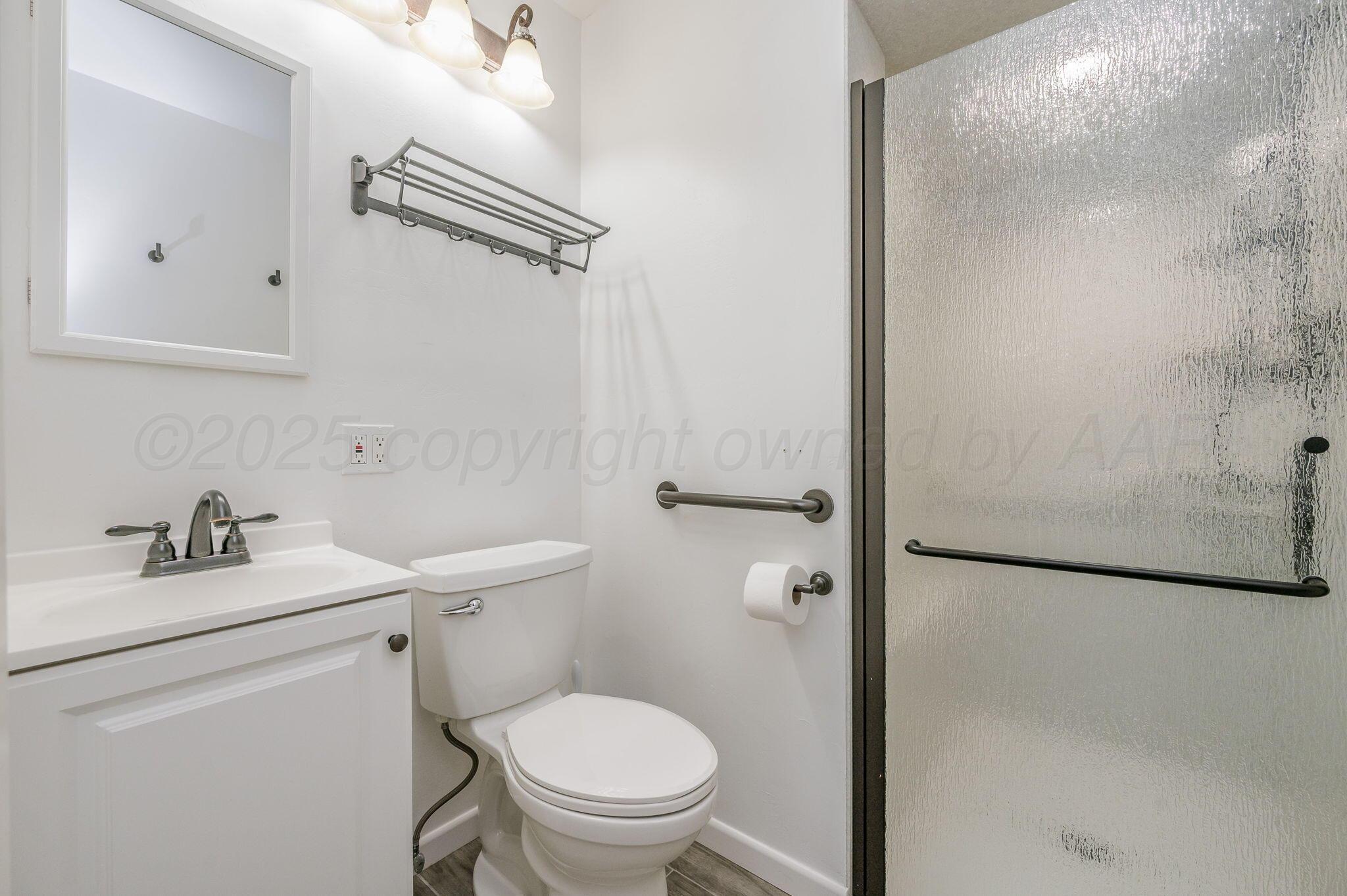 1102 Creekmere Drive Canyon, TX 79015 - Photo 15 of 29 a bathroom with a toilet a sink and a shower