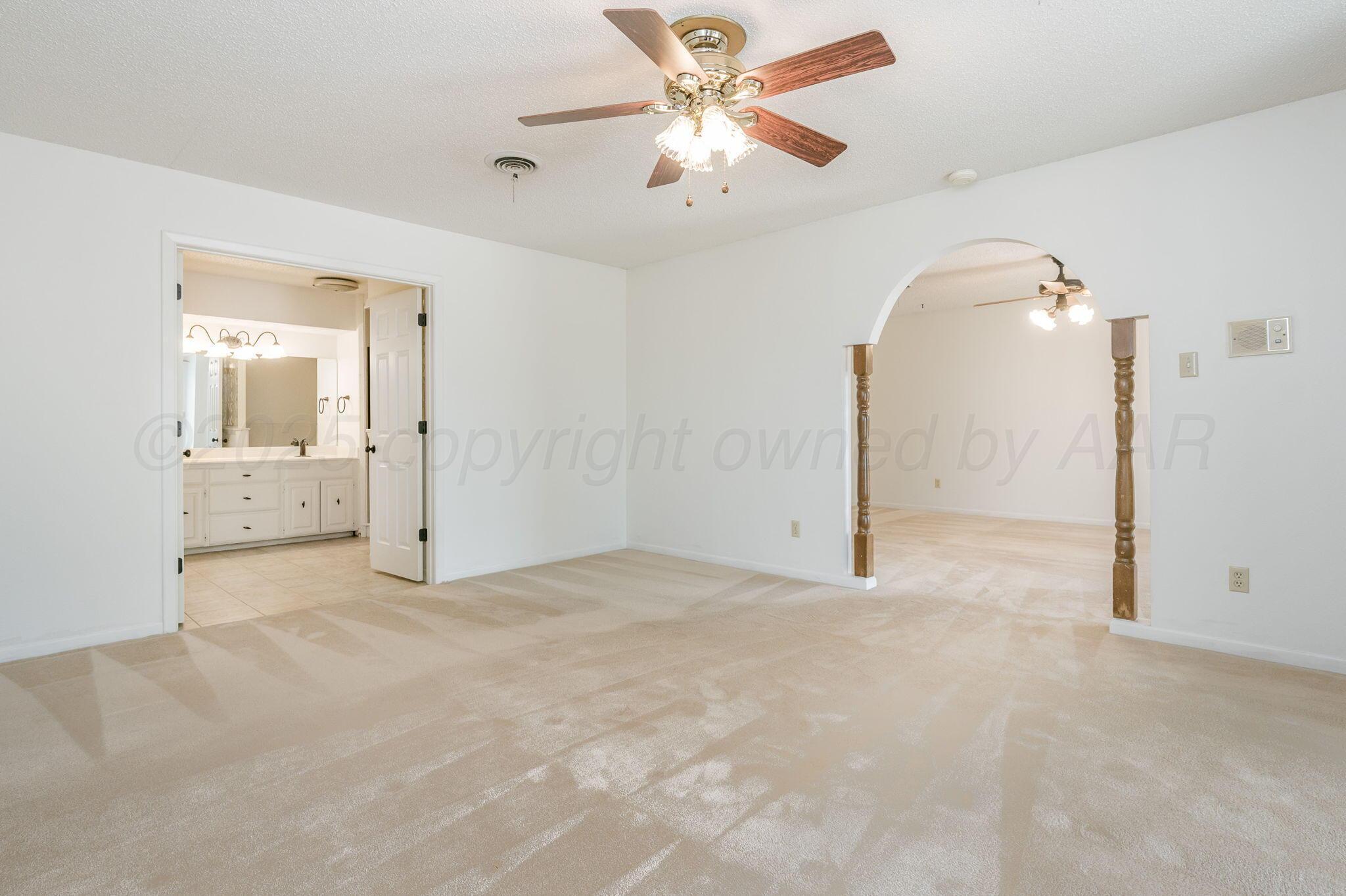 1102 Creekmere Drive Canyon, TX 79015 - Photo 17 of 29 a view of a big room with closet and a chandelier fan