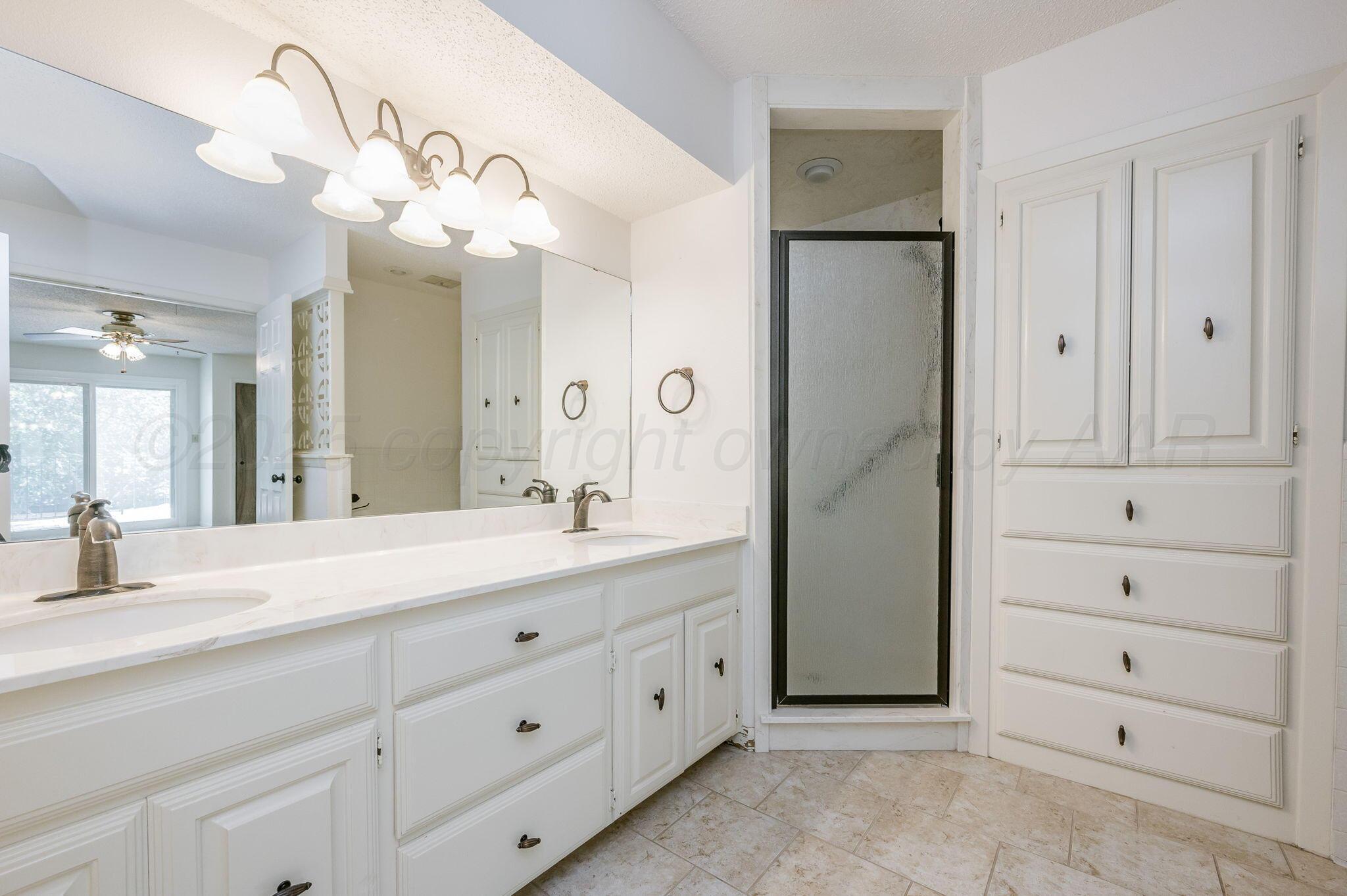 1102 Creekmere Drive Canyon, TX 79015 - Photo 19 of 29 a spacious bathroom with a double vanity sink mirror and double