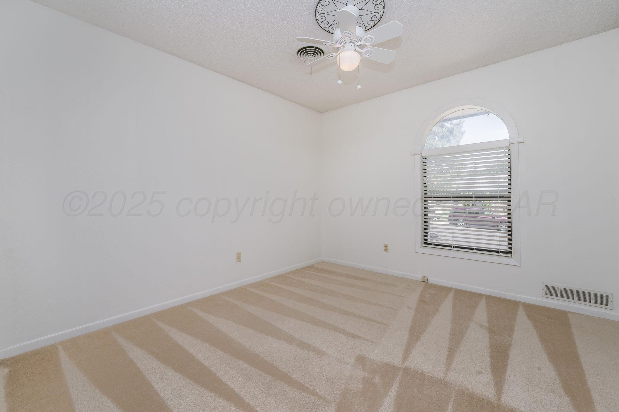 1102 Creekmere Drive Canyon, TX 79015 - Photo 22 of 29 an empty room with a window