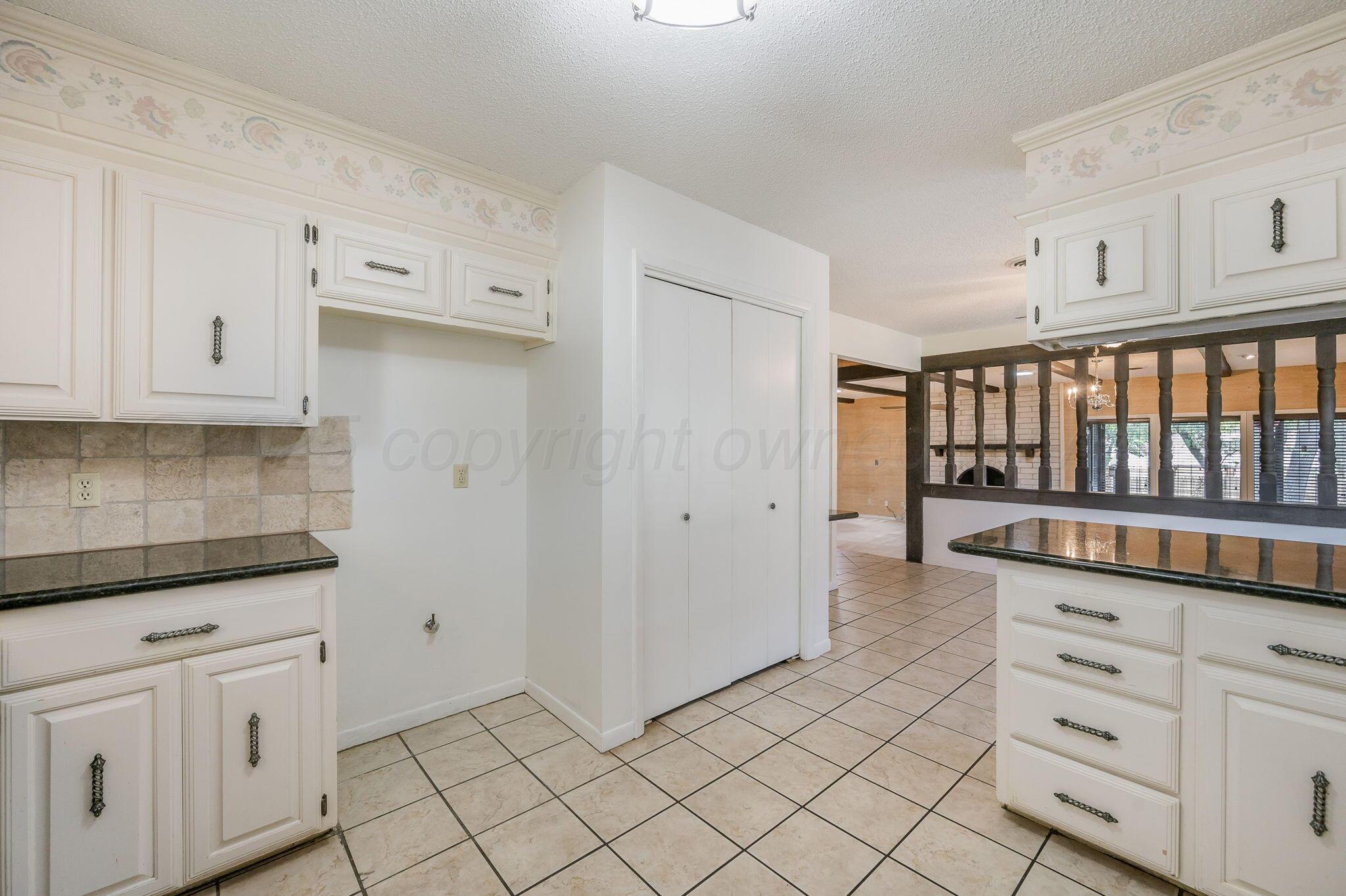 1102 Creekmere Drive Canyon, TX 79015 - Photo 7 of 29 a kitchen with white cabinets and window