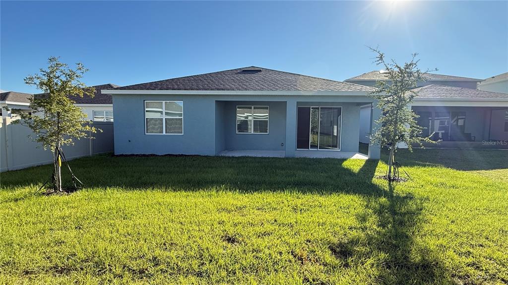 1530 Groveline Road St. Cloud, FL 34771 - Photo 12 of 18 a front view of a house with garden