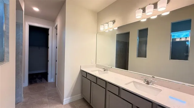 a bathroom with a double vanity sink a and mirror