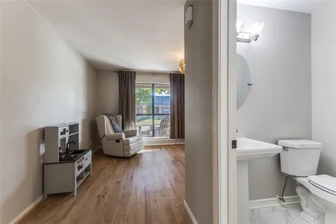 a living room with furniture and a toilet
