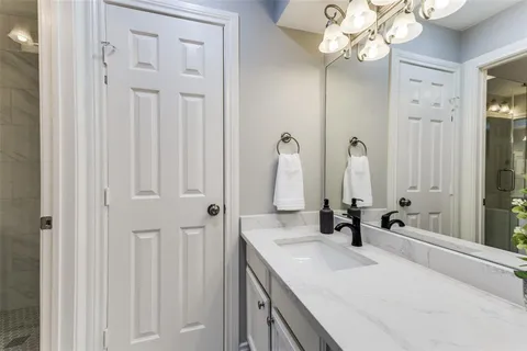 a bathroom with a double vanity sink and a mirror