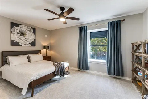 a bedroom with a bed a window and a book shelf