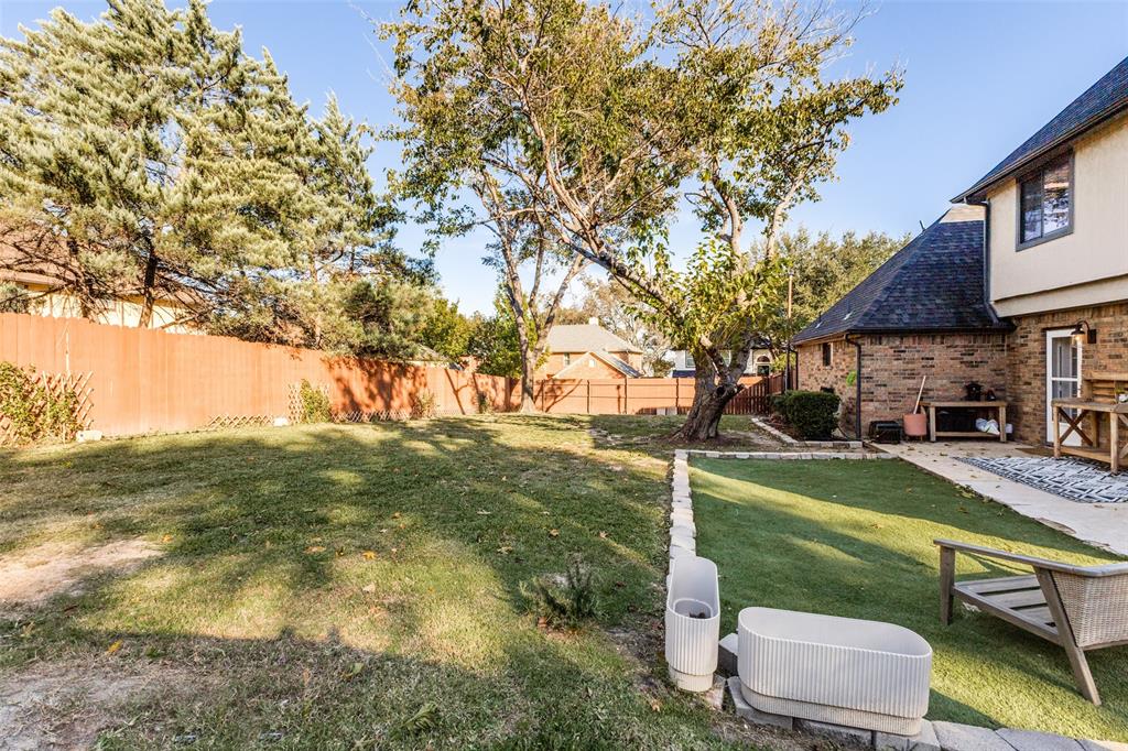 8209 Weatherly Drive Rowlett, TX 75089 - Photo 23 of 25 a backyard of a house with table and chairs