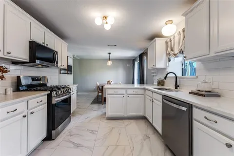 a kitchen with a sink and cabinets
