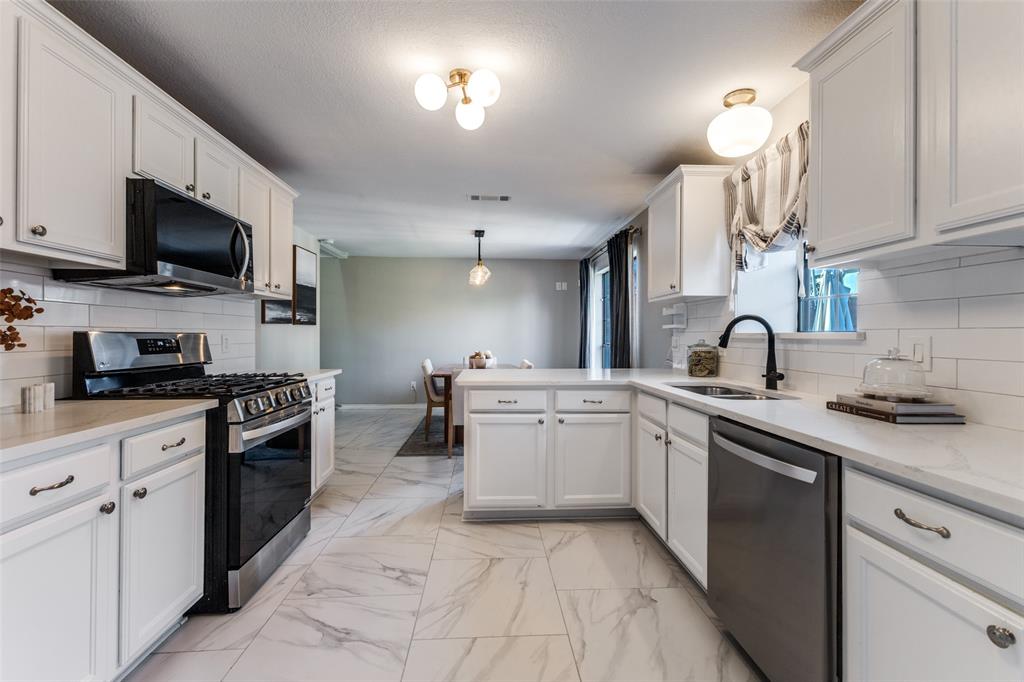 8209 Weatherly Drive Rowlett, TX 75089 - Photo 3 of 25 a kitchen with a sink and cabinets