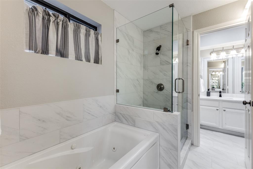 8209 Weatherly Drive Rowlett, TX 75089 - Photo 4 of 25 a bathroom with a bathtub and a shower
