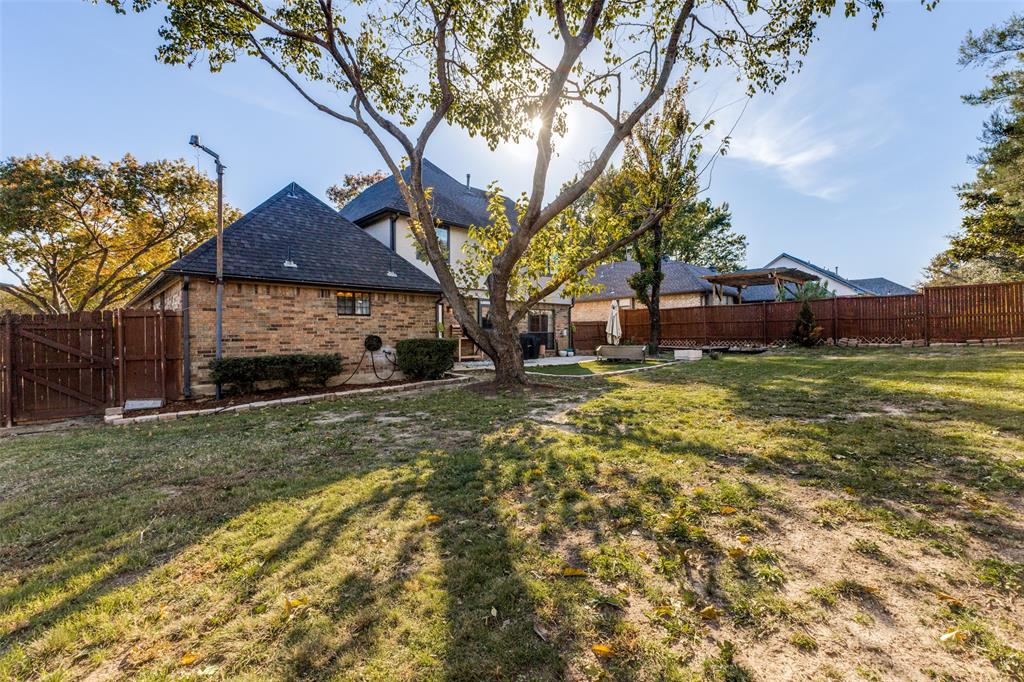 8209 Weatherly Drive Rowlett, TX 75089 - Photo 5 of 25 a view of a yard with a house in the background