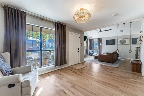 a view of a livingroom with furniture wooden floor and windows