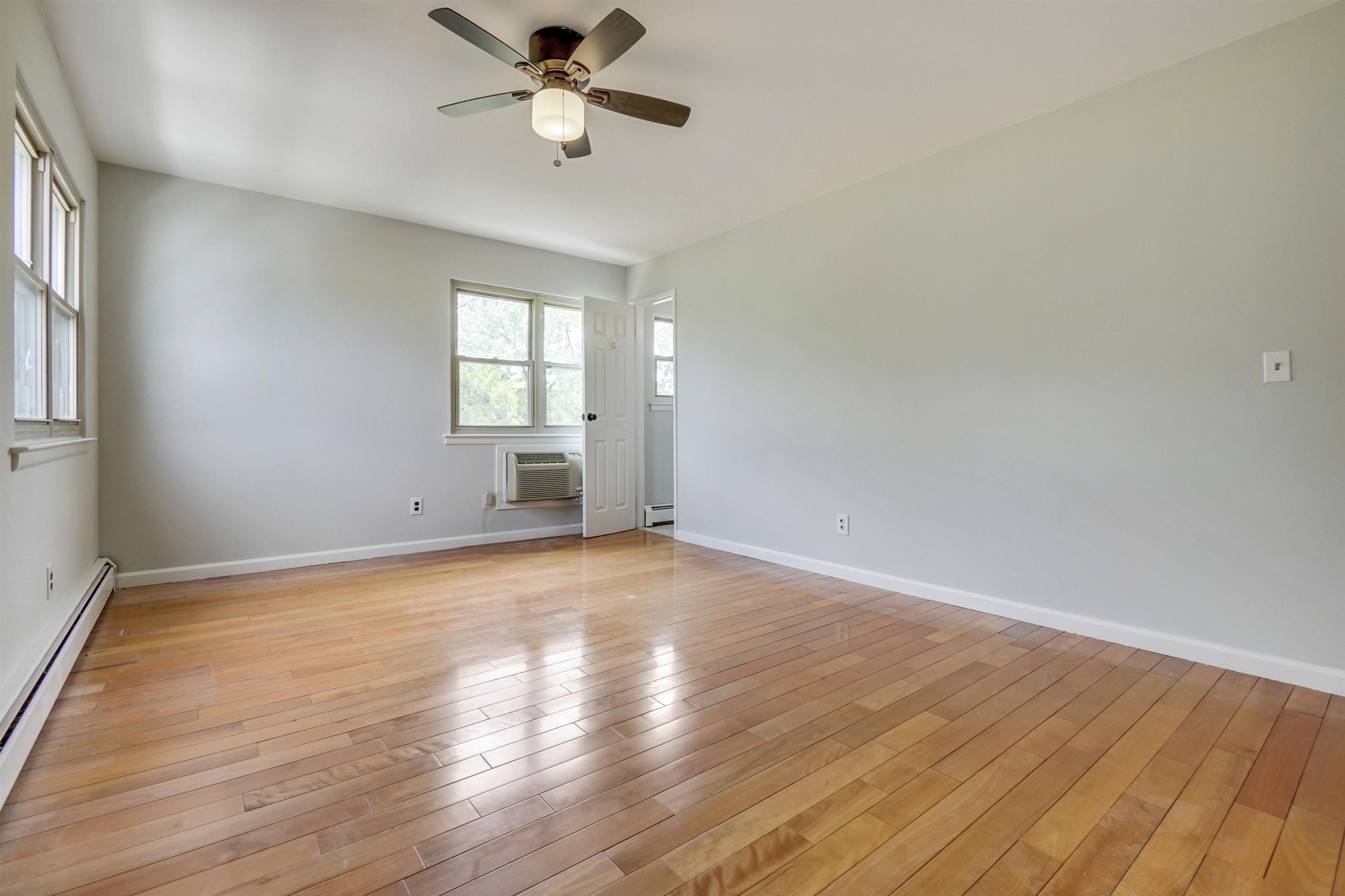 1138F Farm Road, Unit G Secaucus, NJ 07094 - Photo 19 of 26 a view of empty room with wooden floor and fan