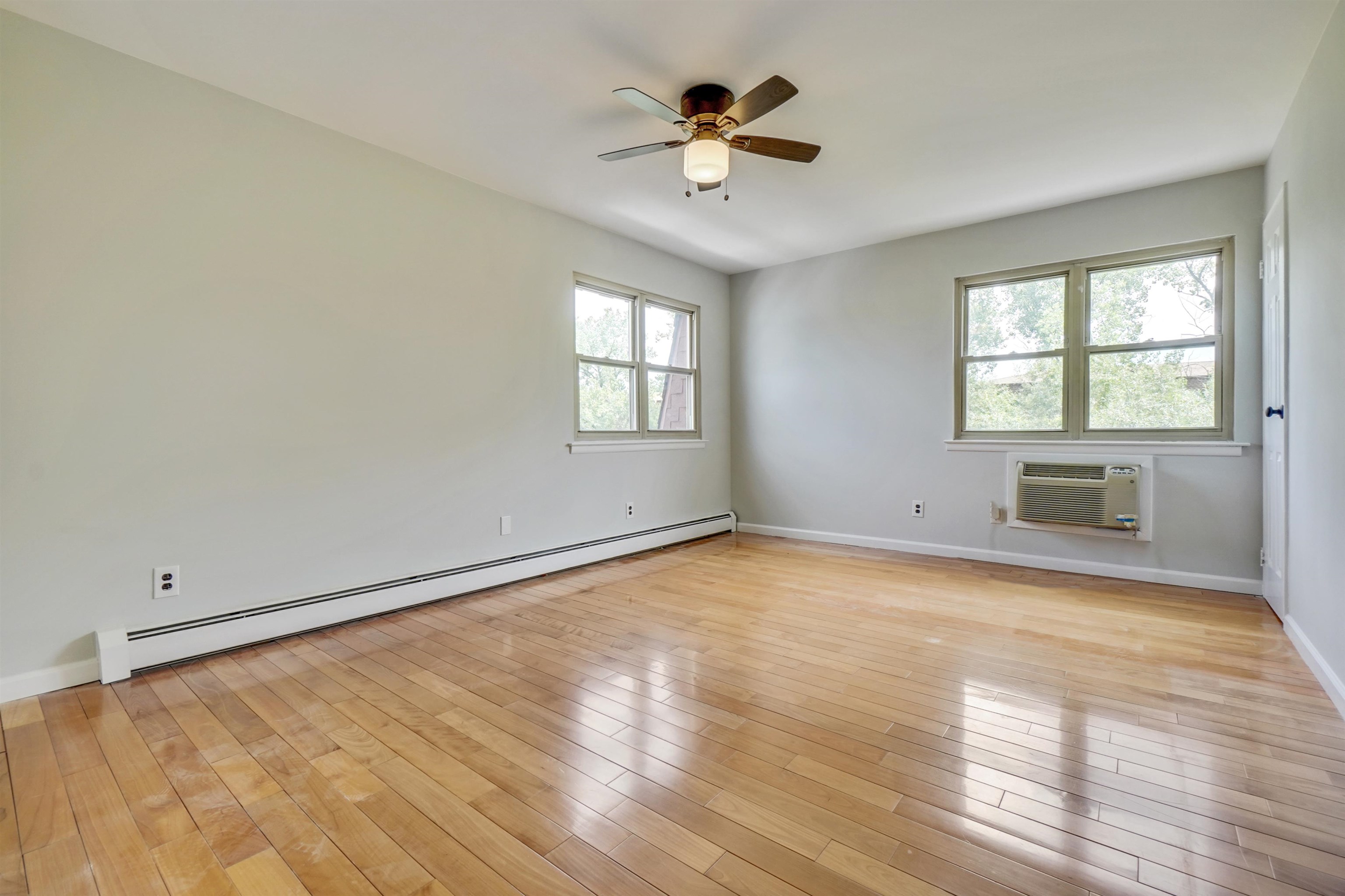 1138F Farm Road, Unit G Secaucus, NJ 07094 - Photo 20 of 26 an empty room with windows and ceiling fan