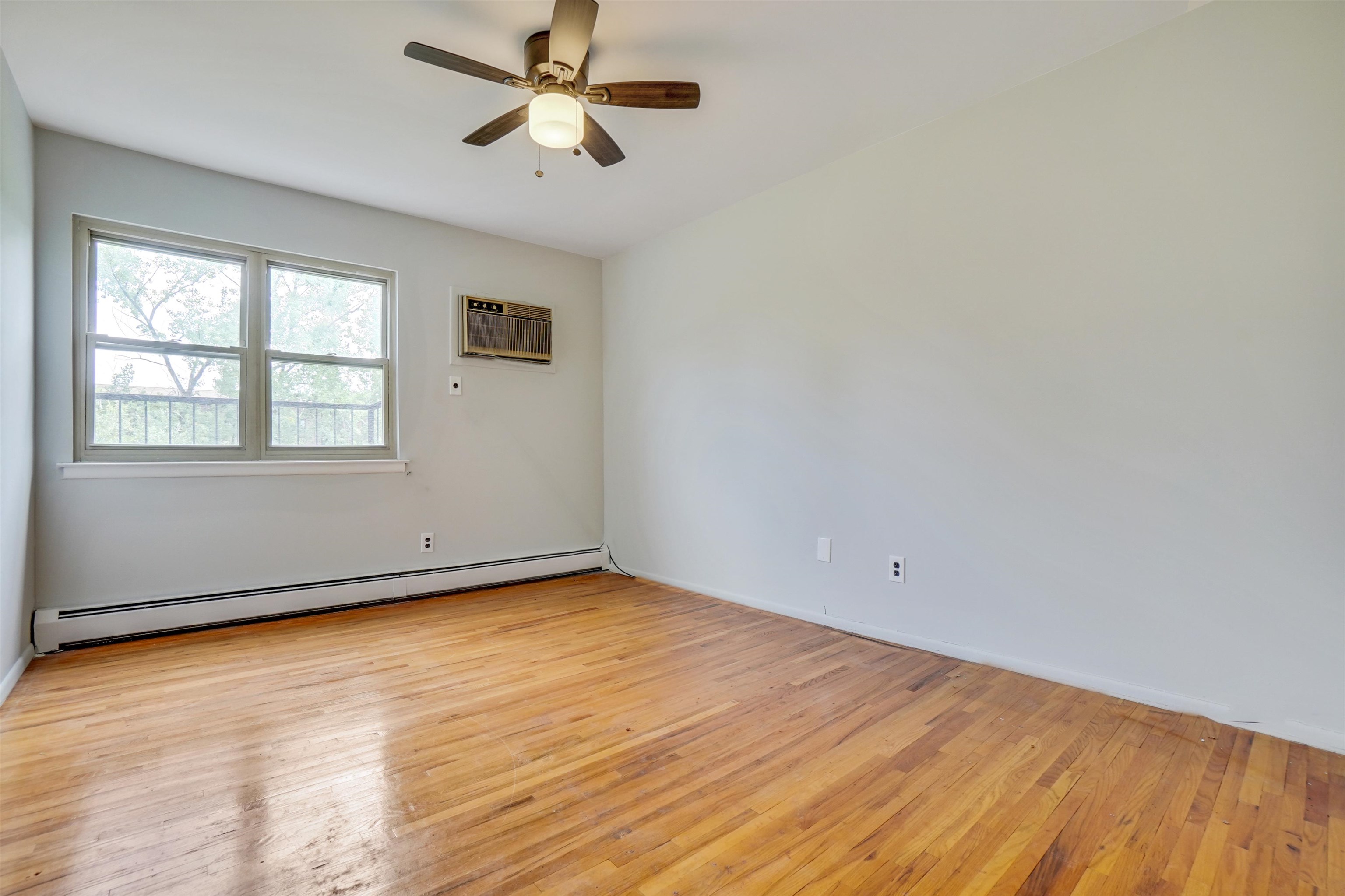 1138F Farm Road, Unit G Secaucus, NJ 07094 - Photo 23 of 26 wooden floor in an empty room with a window