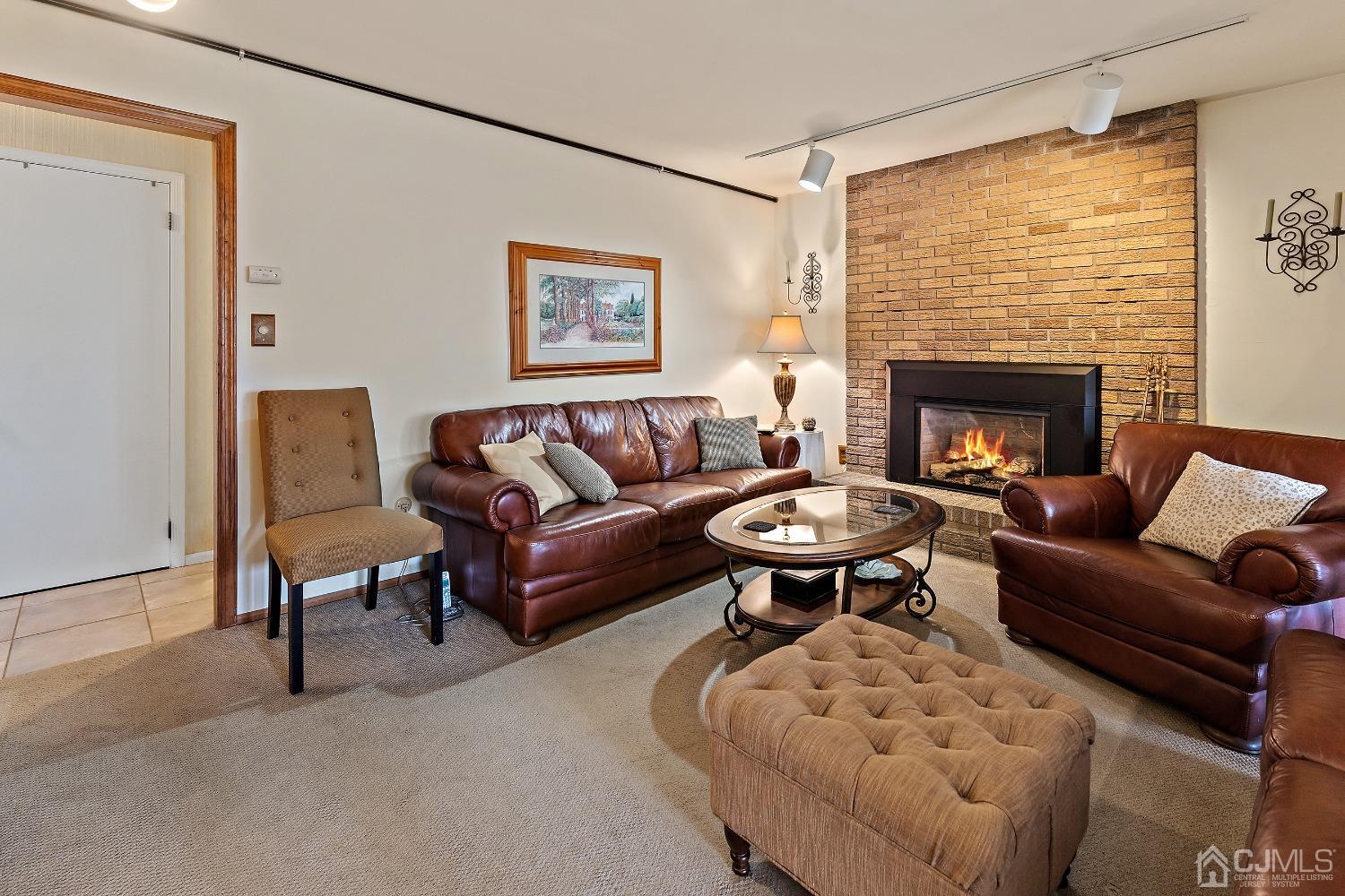 121 Harding Avenue Edison, NJ 08820 - Photo 16 of 30 a living room with furniture a rug and a fireplace