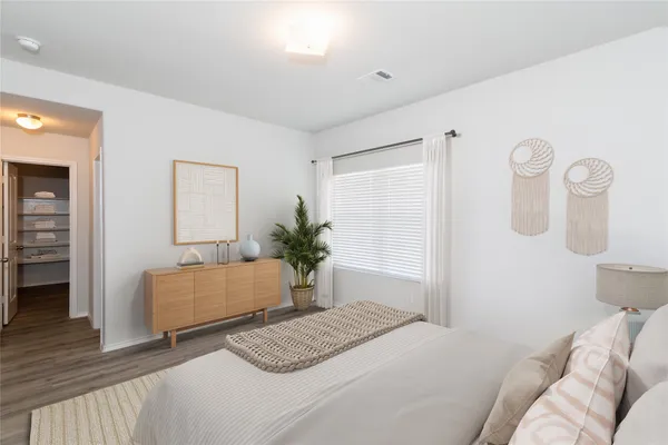 a bedroom with a bed and a dresser