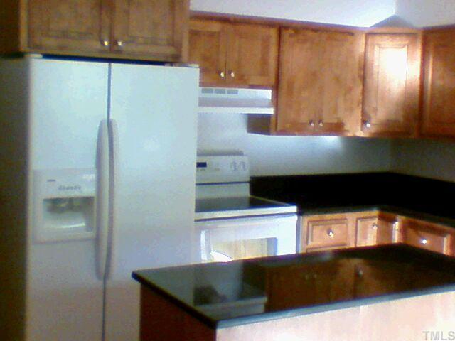 6205 Deerwood Place Raleigh, NC 27607 - Photo 4 of 5 a kitchen with stainless steel appliances a refrigerator and a microwave