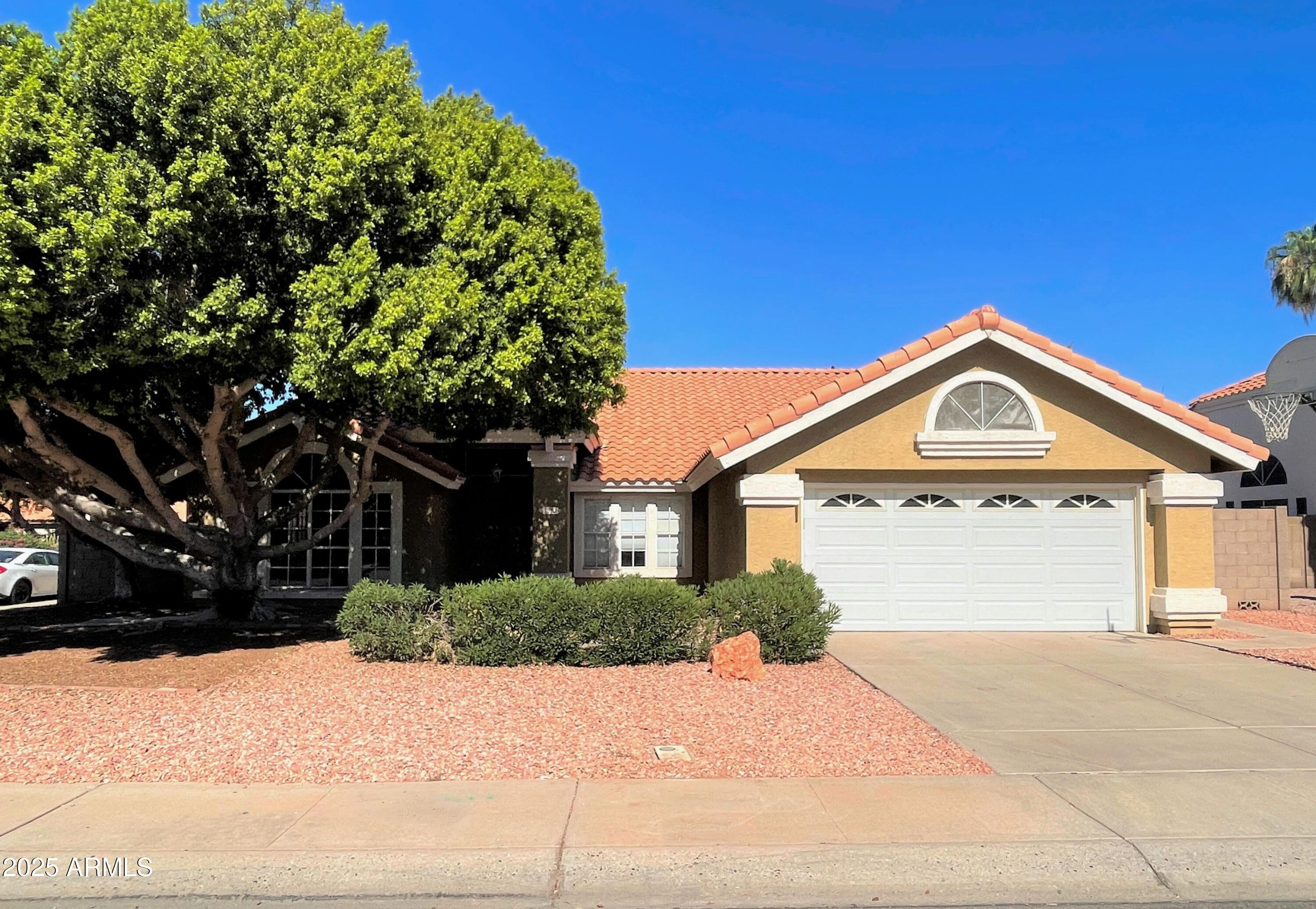1310 North Longmore Street Chandler, AZ 85224 - Photo 1 of 32 a front view of a house with a yard and garage