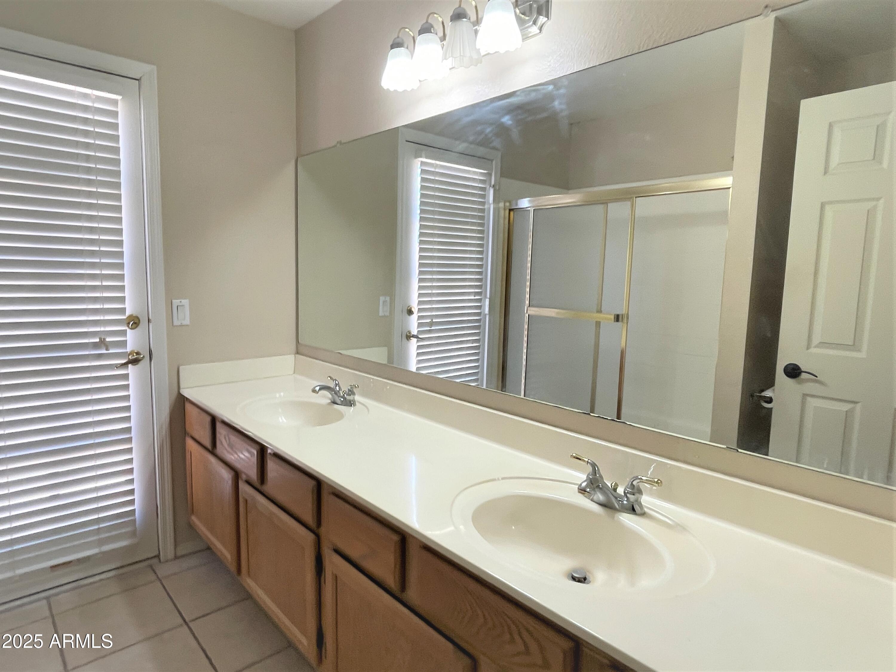 1310 North Longmore Street Chandler, AZ 85224 - Photo 27 of 32 a bathroom with a double vanity sink and a mirror