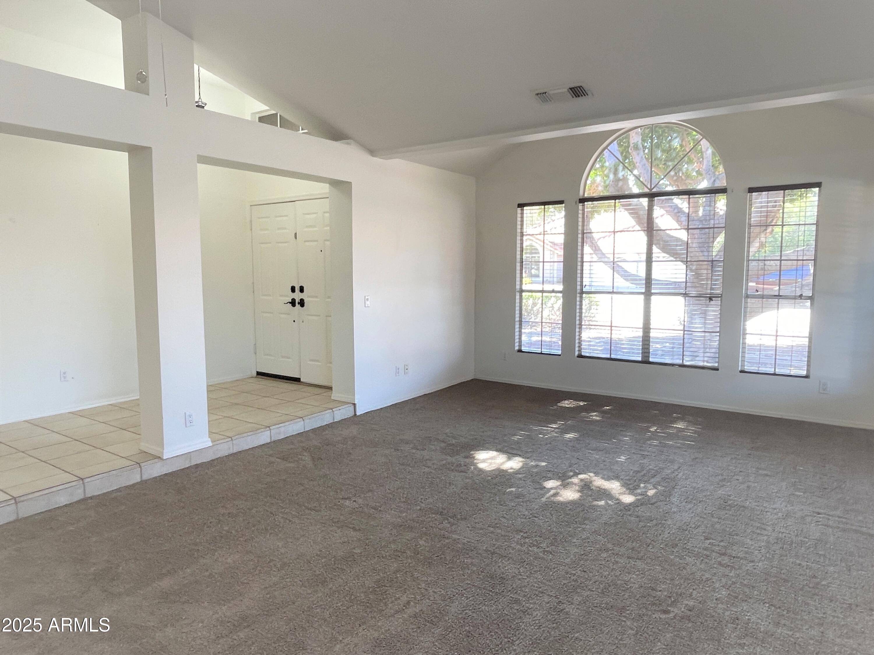 1310 North Longmore Street Chandler, AZ 85224 - Photo 4 of 32 an empty room that has a large window