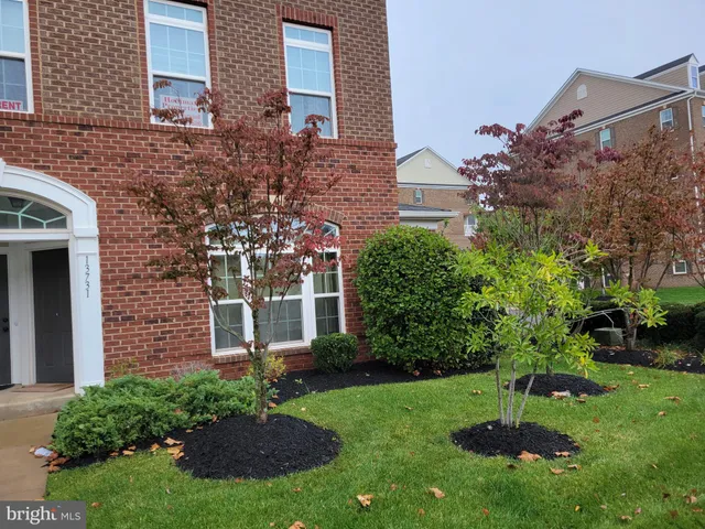 a view of a house with a yard and plants