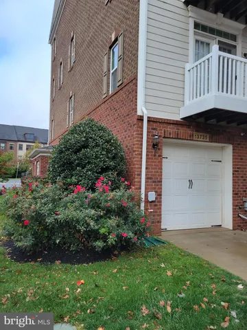 a view of a house with a yard and garden