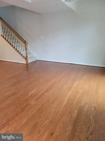 a view of a room with wooden floor