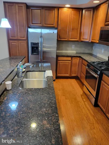 a kitchen with sink a refrigerator and cabinets