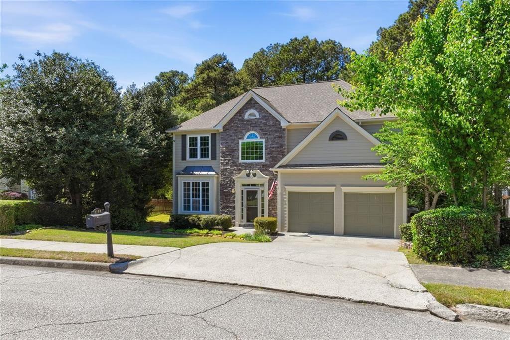 3318 Ridgemill Circle Dacula, GA 30019 - Photo 3 of 106 a front view of a house with a yard and trees