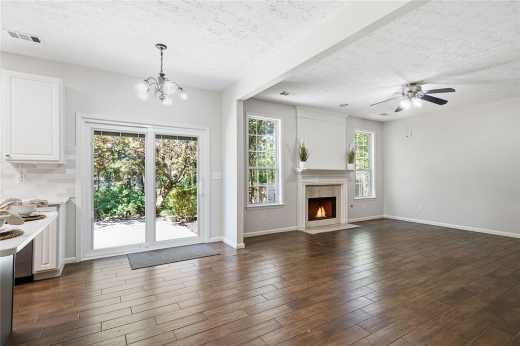 3318 Ridgemill Circle Dacula, GA 30019 - Photo 59 of 106 a view of a livingroom with a fireplace wooden floor and chandelier
