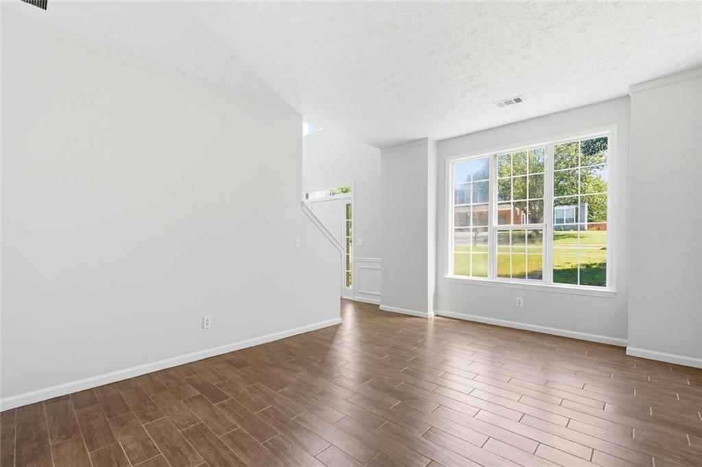 3318 Ridgemill Circle Dacula, GA 30019 - Photo 64 of 106 an empty room with wooden floor and windows