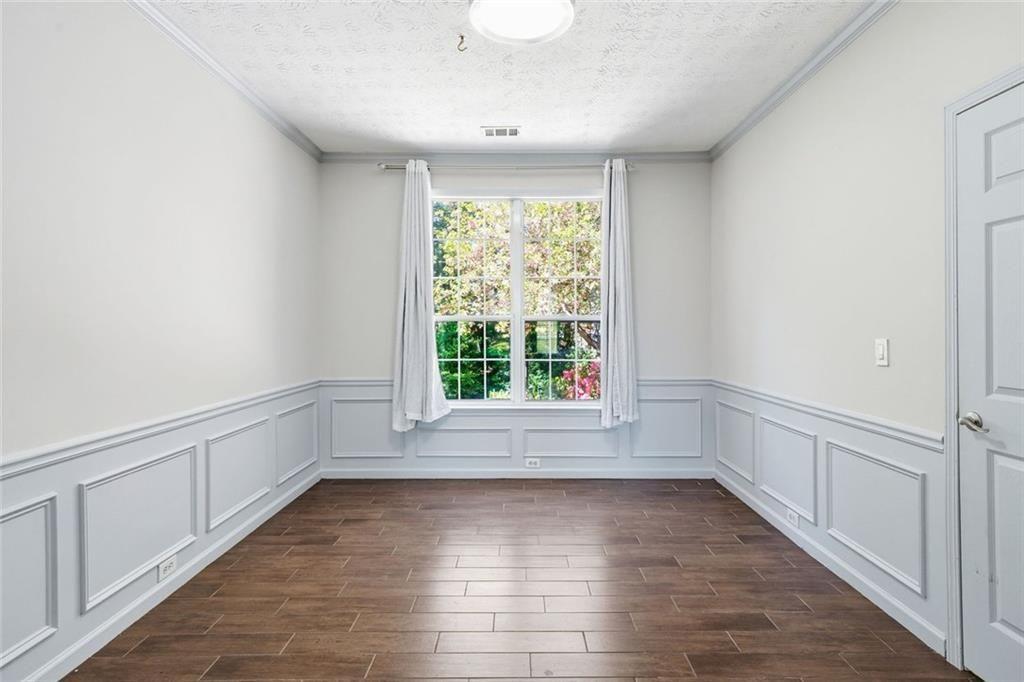 3318 Ridgemill Circle Dacula, GA 30019 - Photo 67 of 106 a view of an empty room with wooden floor and a window