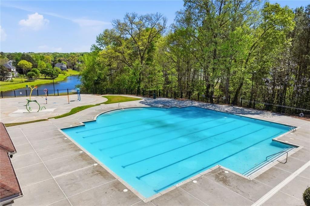 3318 Ridgemill Circle Dacula, GA 30019 - Photo 91 of 106 a view of a swimming pool with an outdoor space and seating area