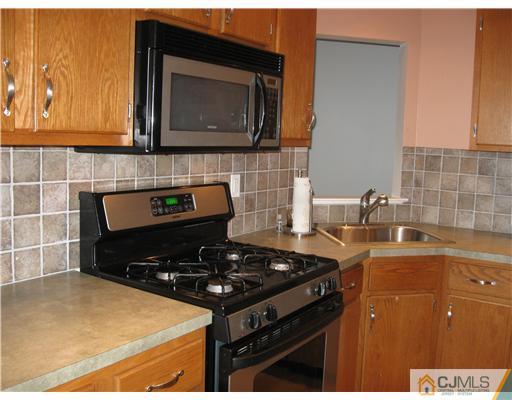 36 Farnham Square Sayreville, NJ 08859 - Photo 2 of 16 a kitchen with a stove and a microwave