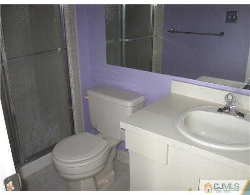 36 Farnham Square Sayreville, NJ 08859 - Photo 14 of 16 a white toilet sitting next to a bathroom sink