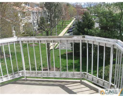 36 Farnham Square Sayreville, NJ 08859 - Photo 16 of 16 a view of a balcony with a floor to ceiling window and wooden fence