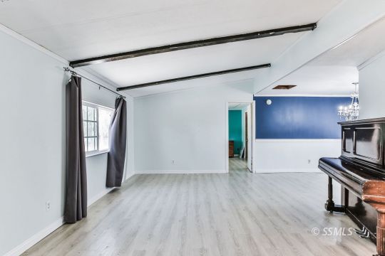 4511 Stark Street Ridgecrest, CA 93555 - Photo 4 of 30 a view of an empty room with wooden floor and a window