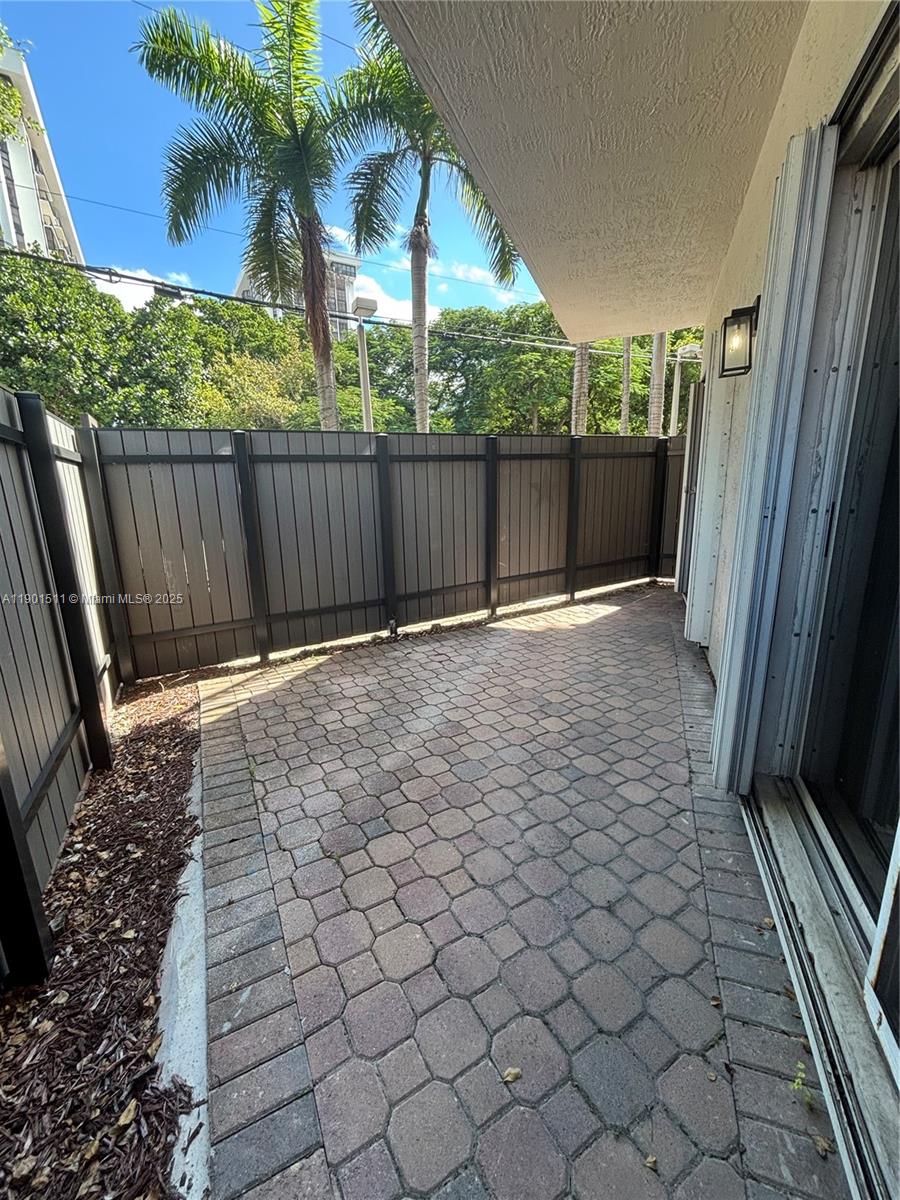 1918 Brickell Avenue, Unit 101 Miami, FL 33129 - Photo 16 of 21 a view of backyard with wooden fence