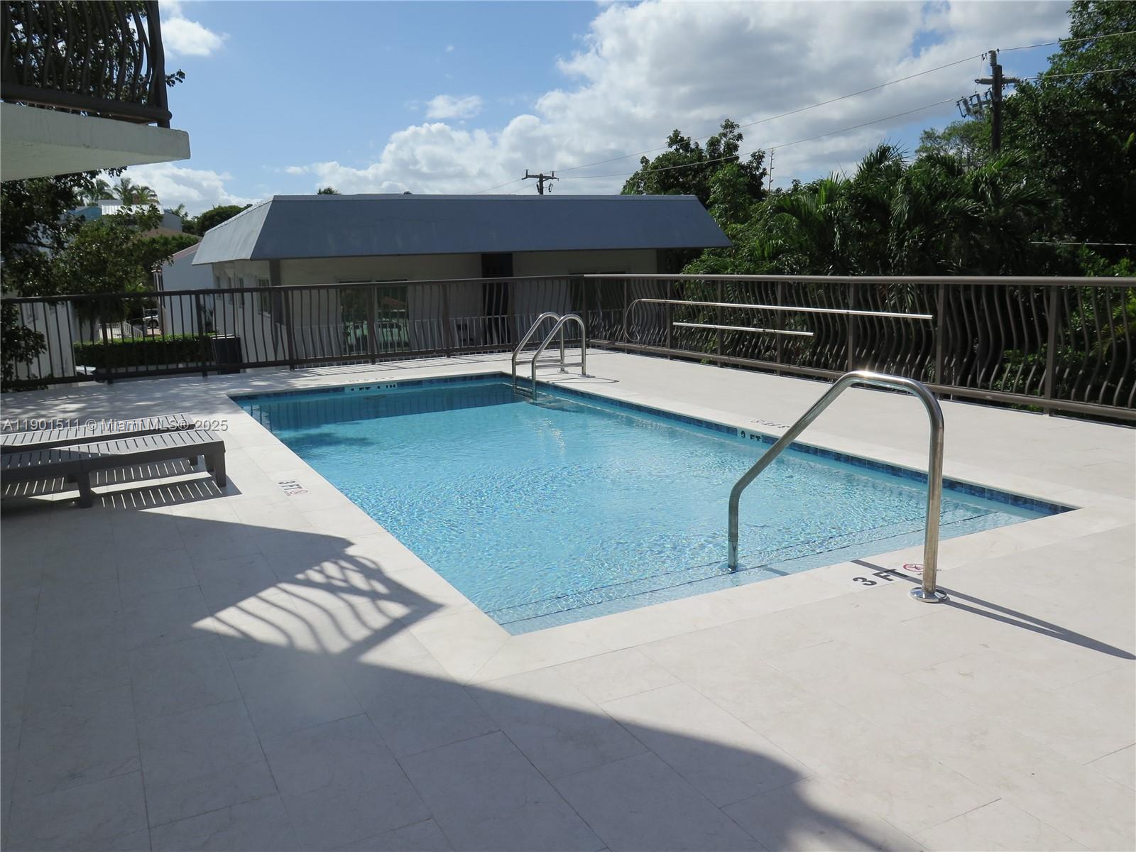 1918 Brickell Avenue, Unit 101 Miami, FL 33129 - Photo 20 of 21 a view of a patio with table and chairs with wooden floor and fence