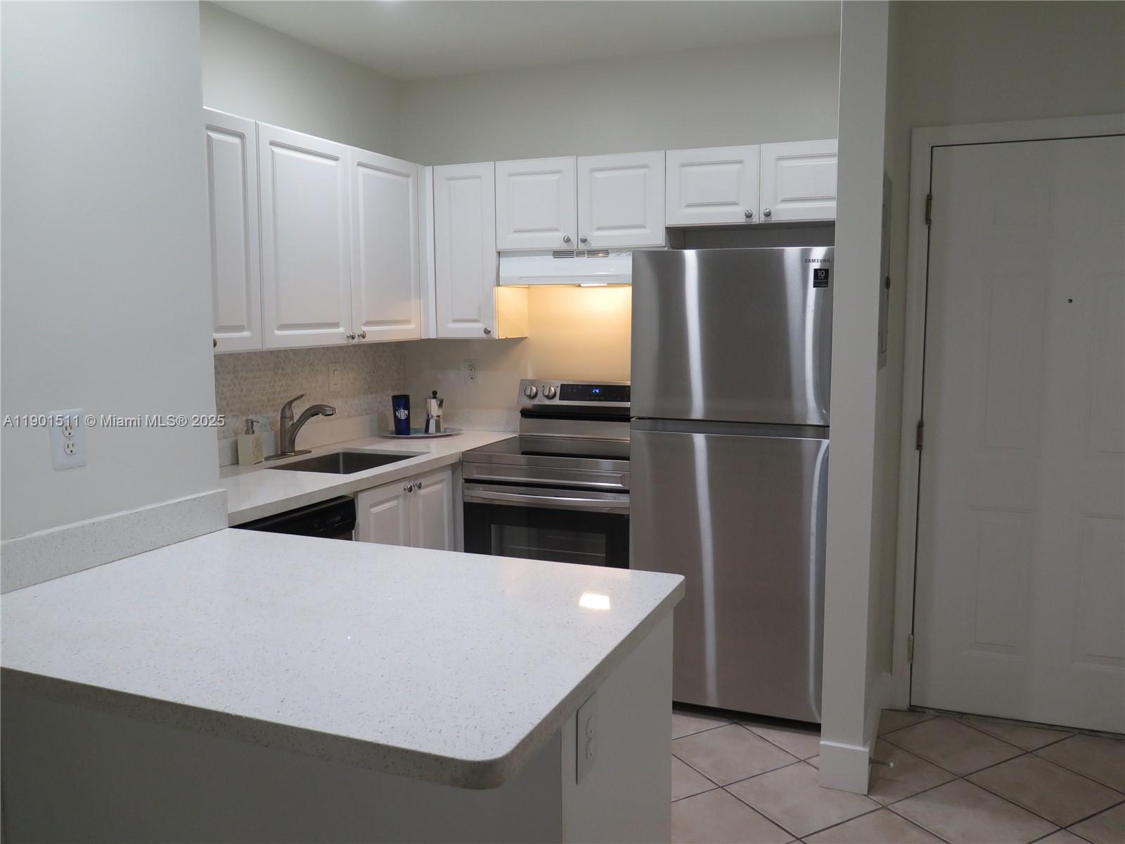 1918 Brickell Avenue, Unit 101 Miami, FL 33129 - Photo 7 of 21 a kitchen with stainless steel appliances a refrigerator and a stove top oven