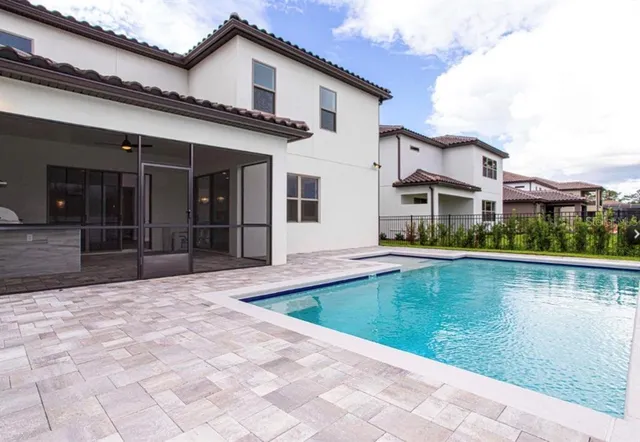 a view of a hallway with wooden floor and a bathroom