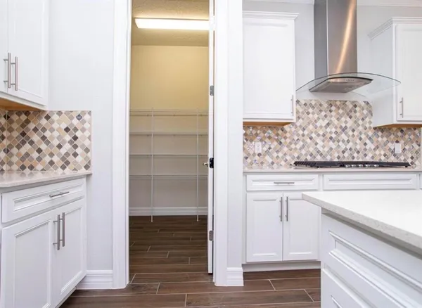 a spacious bathroom with a double vanity sink a large mirror and shower