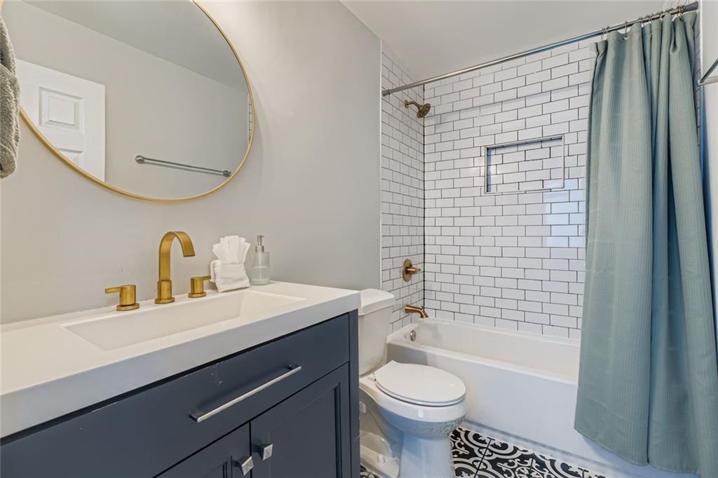 677 Ira Street Southwest Atlanta, GA 30310 - Photo 23 of 28 a bathroom with a sink toilet and shower